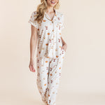 Model posing in Women's Short Sleeve Cropped Pajama Set in Pumpkin Spice Latte print on a beige background
---PJ 4