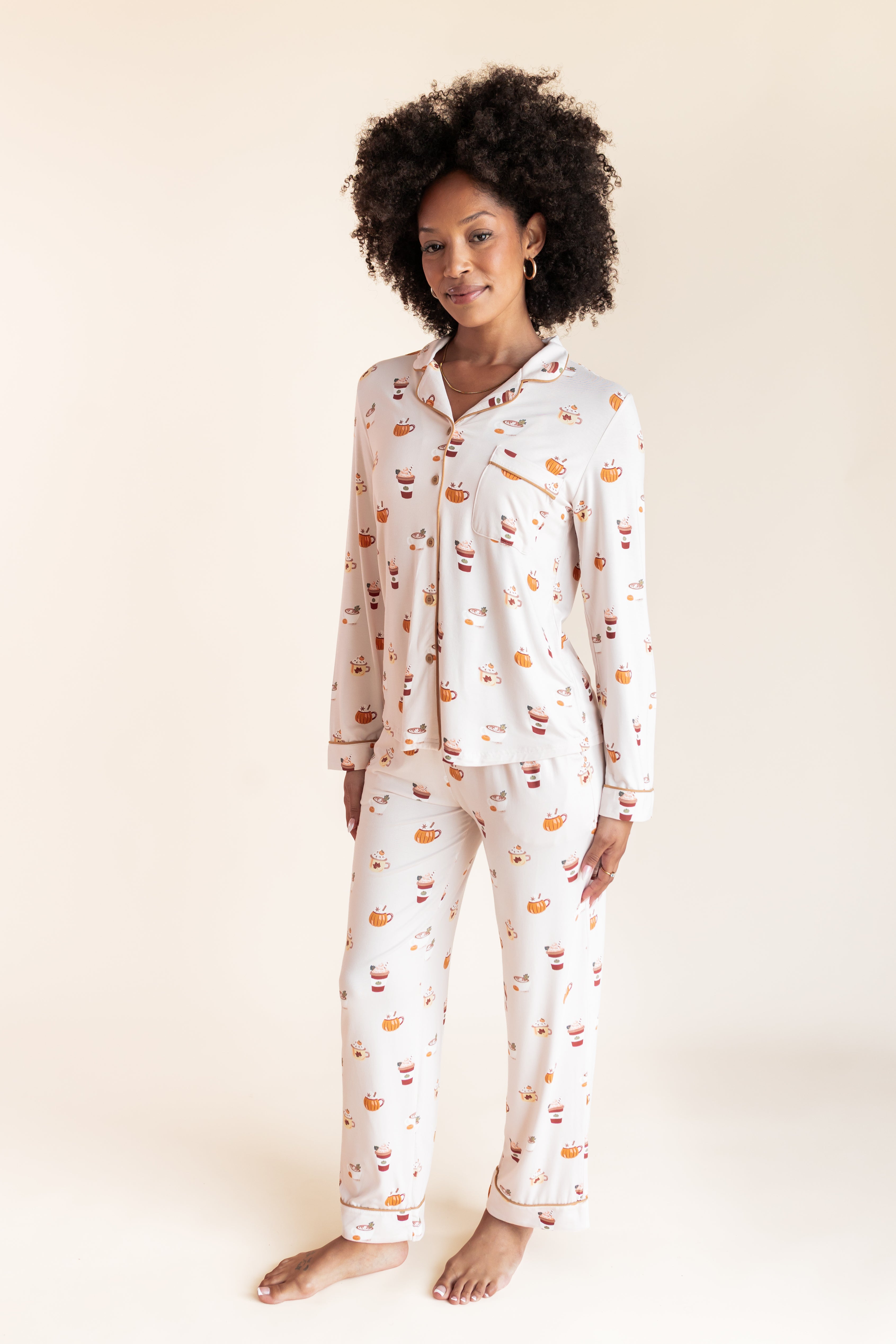 Model wearing Long-Sleeved Women's Pajama Set in Pumpkin Spice Latte print on a beige background
::: Model is 5'9"" wearing size S ///