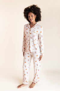 Model wearing Long-Sleeved Women's Pajama Set in Pumpkin Spice Latte print on a beige background