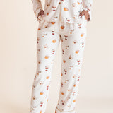 Model showcasing the front side pajamas of Long-Sleeved Women's Pajama Set in Pumpkin Spice Latte print on a beige background
---1605 3