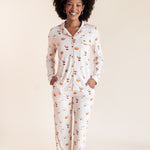 Model smiling in Long-Sleeved Women's Pajama Set in Pumpkin Spice Latte print on a beige background
---PJ 4