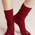 Model wearing Adult Scrunch Socks in Ruby shown on a beige background