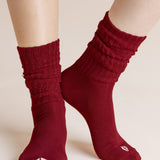 Model wearing Adult Scrunch Socks in Ruby shown on a beige background