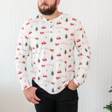 Male model looking to the side while wearing the Kyte Men's Long Sleeve Henley Top in Santa Sleigh