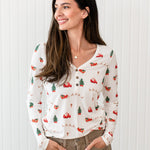 Woman with hands in light brown pants paired with the Kyte Women's Long Sleeve Henley Tee in Santa Sleigh