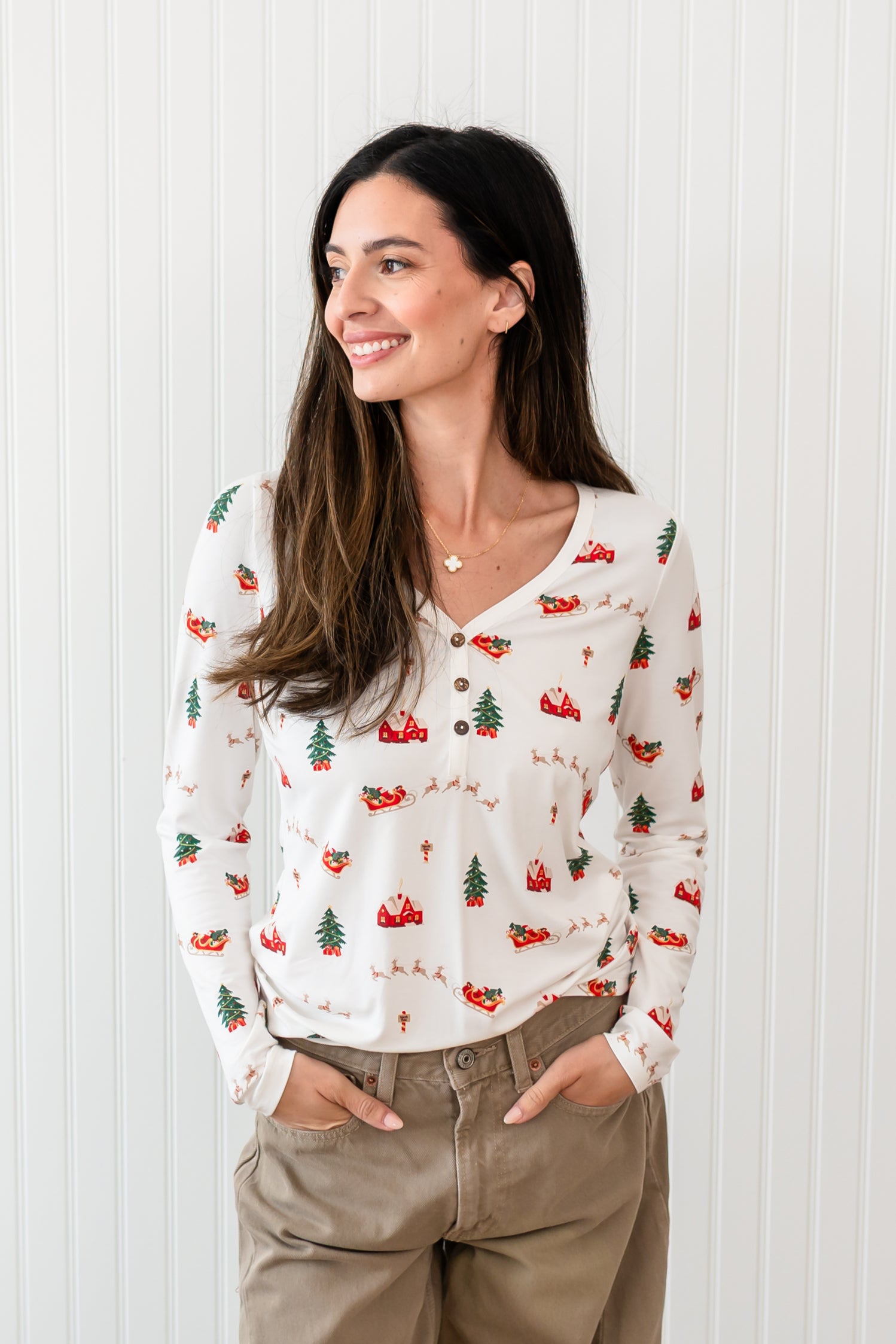 Woman with hands in light brown pants paired with the Kyte Women's Long Sleeve Henley Tee in Santa Sleigh