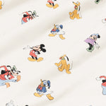 Close up of bamboo fabric swatch: An all-over print featuring: Mickey Mouse in his classic red shorts with white buttons and yellow shoes; Minnie Mouse wearing a blue headbow, a pink dress, and green heels; Goofy jumping in the air and wearing a green hat, a red shirt, blue pants, and orange shoes; Pluto wearing a green collar; and Donald Duck in his classic blue sailor outfit and hat, over a warm grey background color called Oat.