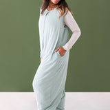 Female modeling the Adult Sleep Bag Walker in Sage with one hand in the pocket