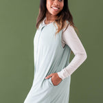 Closer up photo of female wearing the Adult Sleep Bag Walker in Sage with one hand in the pocket
