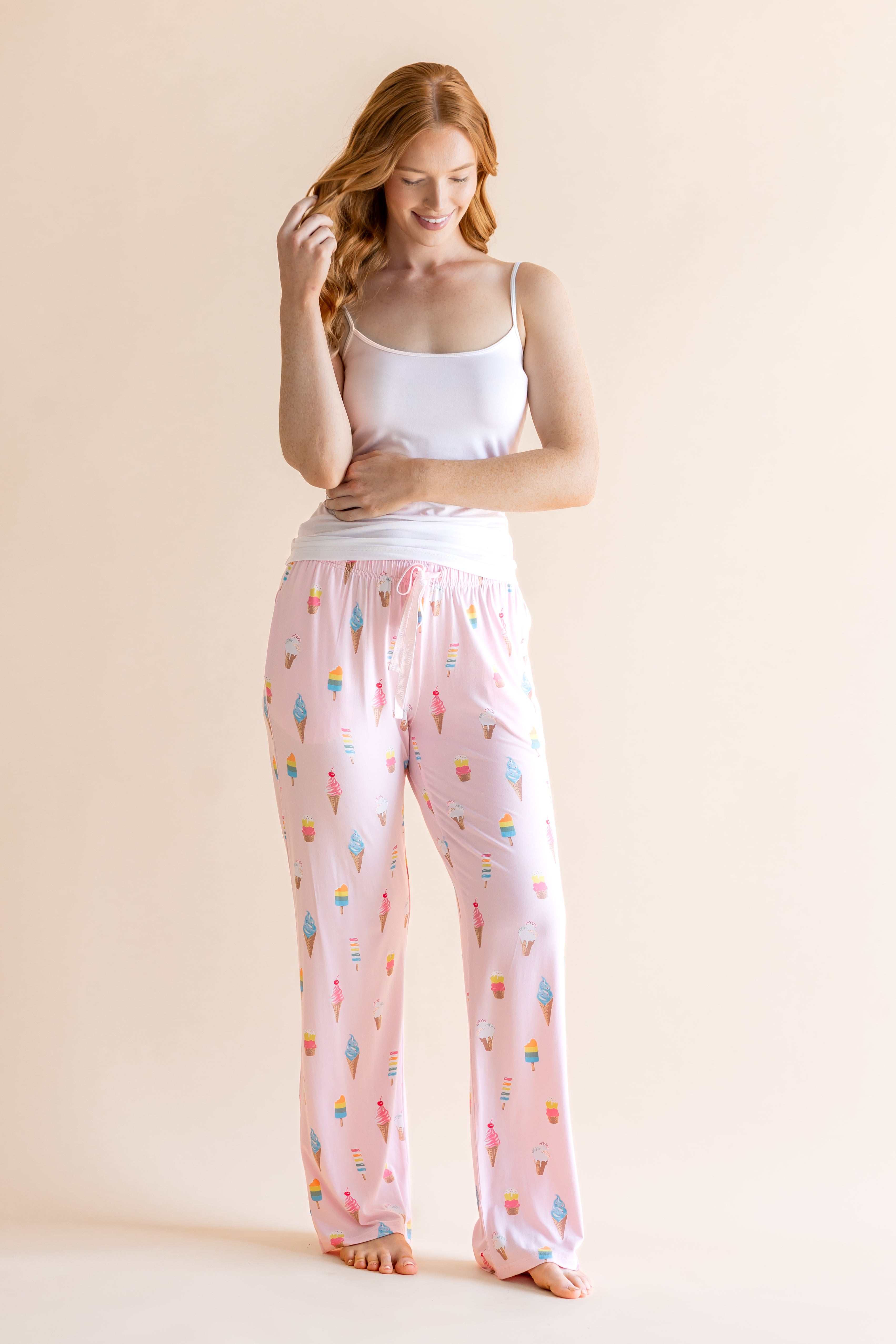 Model wearing the Women's Lounge Pants in Sakura Ice Cream paired with camisole in Cloud 
