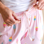 Model wearing Pink Women's Lounge Pants in Ice Cream print with drawstring under white camisole