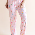 Model in Pink Women's Lounge Pants in Ice Cream print with drawstring under white camisole on beige background