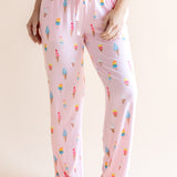Model in Pink Women's Lounge Pants in Ice Cream print with drawstring under white camisole on beige background