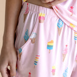 Model showcasing the Women's Tank Set Shorts in Sakura Ice Cream print on beige background