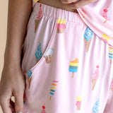 Model showcasing the Women's Tank Set Shorts in Sakura Ice Cream print on beige background