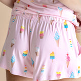 Model showcasing the back of Women's Tank Set shorts in Sakura Ice Cream print on beige background
