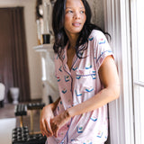 woman wearing pink short sleeve pajama set with mahjong tile print standing against a wall in a living room

---PJ 4

::: Model is 5'10" wearing size S ///