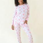 Woman modeling Women's Jogger Pajama Set in Sakura Peony showing there is front pockets
