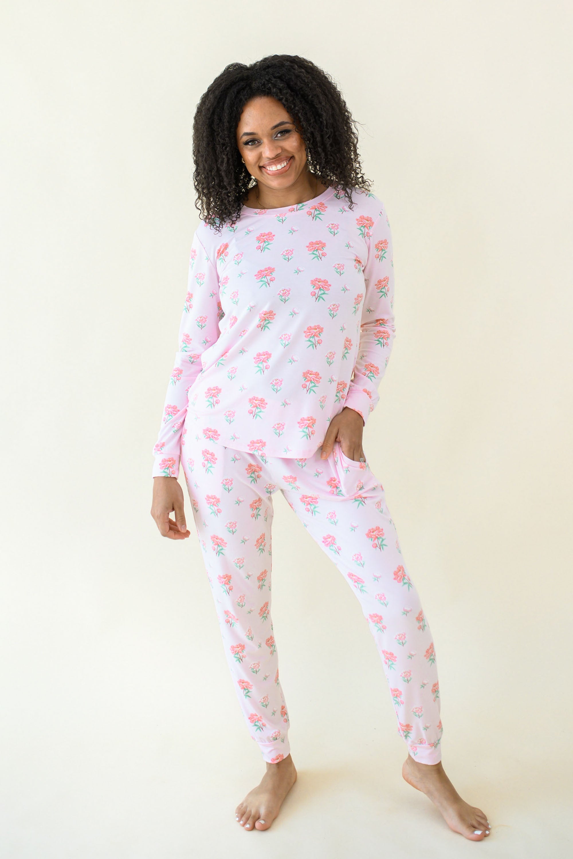 Woman modeling Women's Jogger Pajama Set in Sakura Peony showing there is front pockets