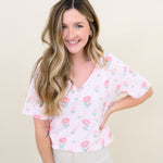 Woman modeling Women's Relaxed Fit V-Neck in Sakura Peony and light colored pants