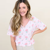 Woman modeling Women's Relaxed Fit V-Neck in Sakura Peony and light colored pants