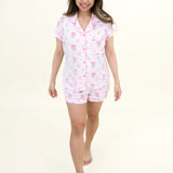 Woman smiling and modeling Women's Short Sleeve Pajama Set in Sakura Peony 