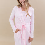 Smiling model wearing the Women’s Lounge Robe in Sakura with one hand in pocket