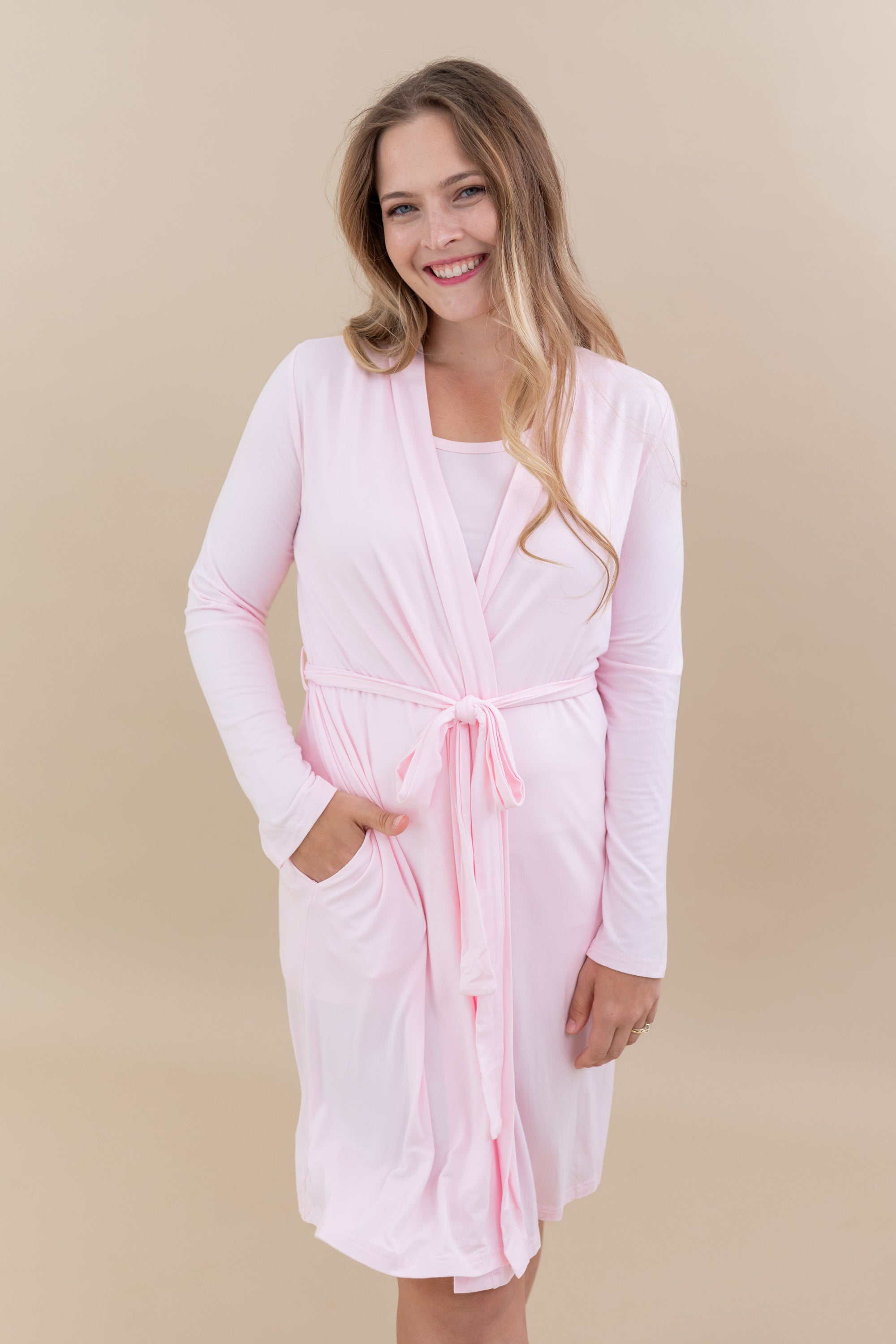 Smiling model wearing the Women’s Lounge Robe in Sakura with one hand in pocket