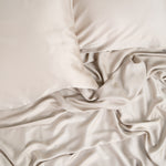 Close up of the Bamboo Sateen Sheet Set in Sand Stone shown on a bed