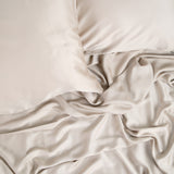Close up of the Bamboo Sateen Sheet Set in Sand Stone shown on a bed