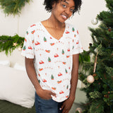 Smiling woman modeling the Kyte Women's Relaxed Fit V-Neck in Santa Sleigh