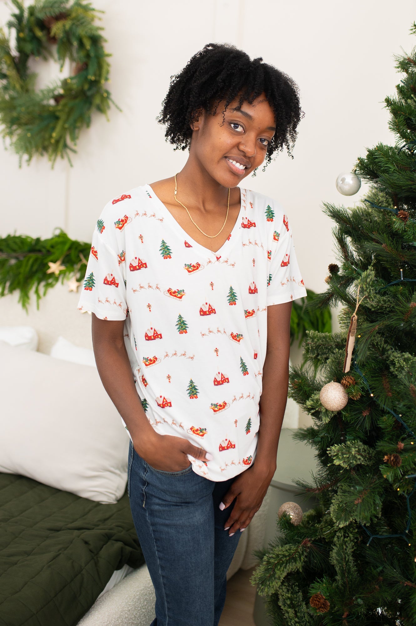 Smiling woman modeling the Kyte Women's Relaxed Fit V-Neck in Santa Sleigh