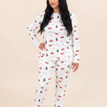 Woman looking to the side while modeling the Kyte Women's Jogger Pajama Set in Santa Sleigh
