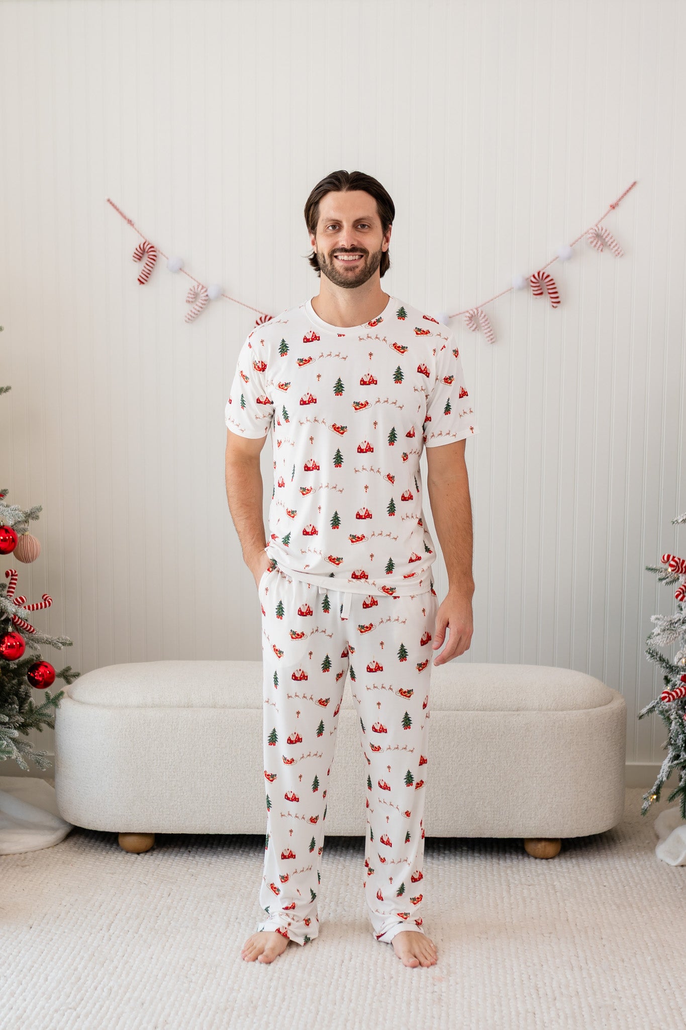 Male model wearing the Men's Crew Neck Tee in Santa Sleigh paired with matching lounge pants
