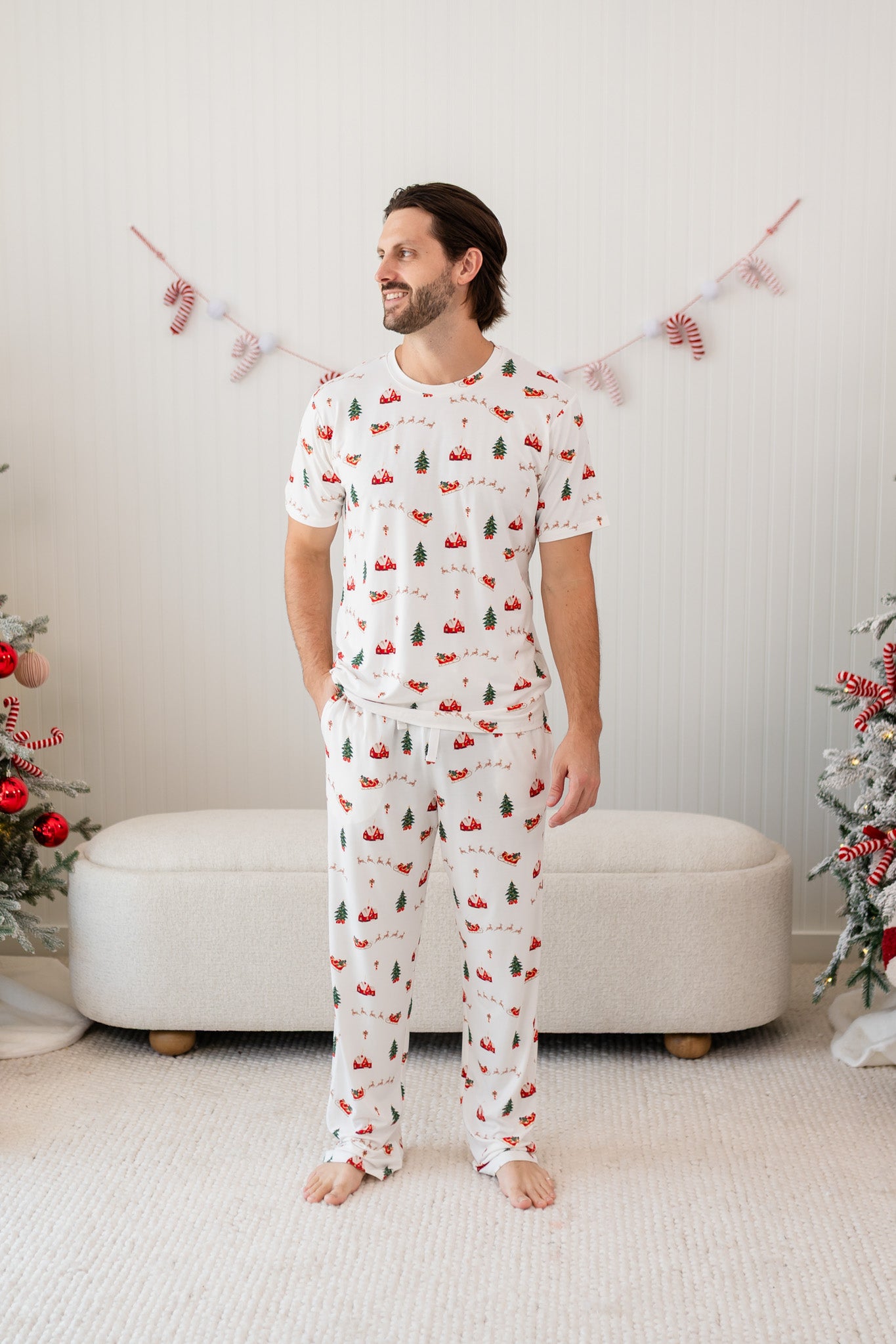 Male model wearing the Men's Lounge Pants in Santa Sleigh paired with matching Crew Neck Tee