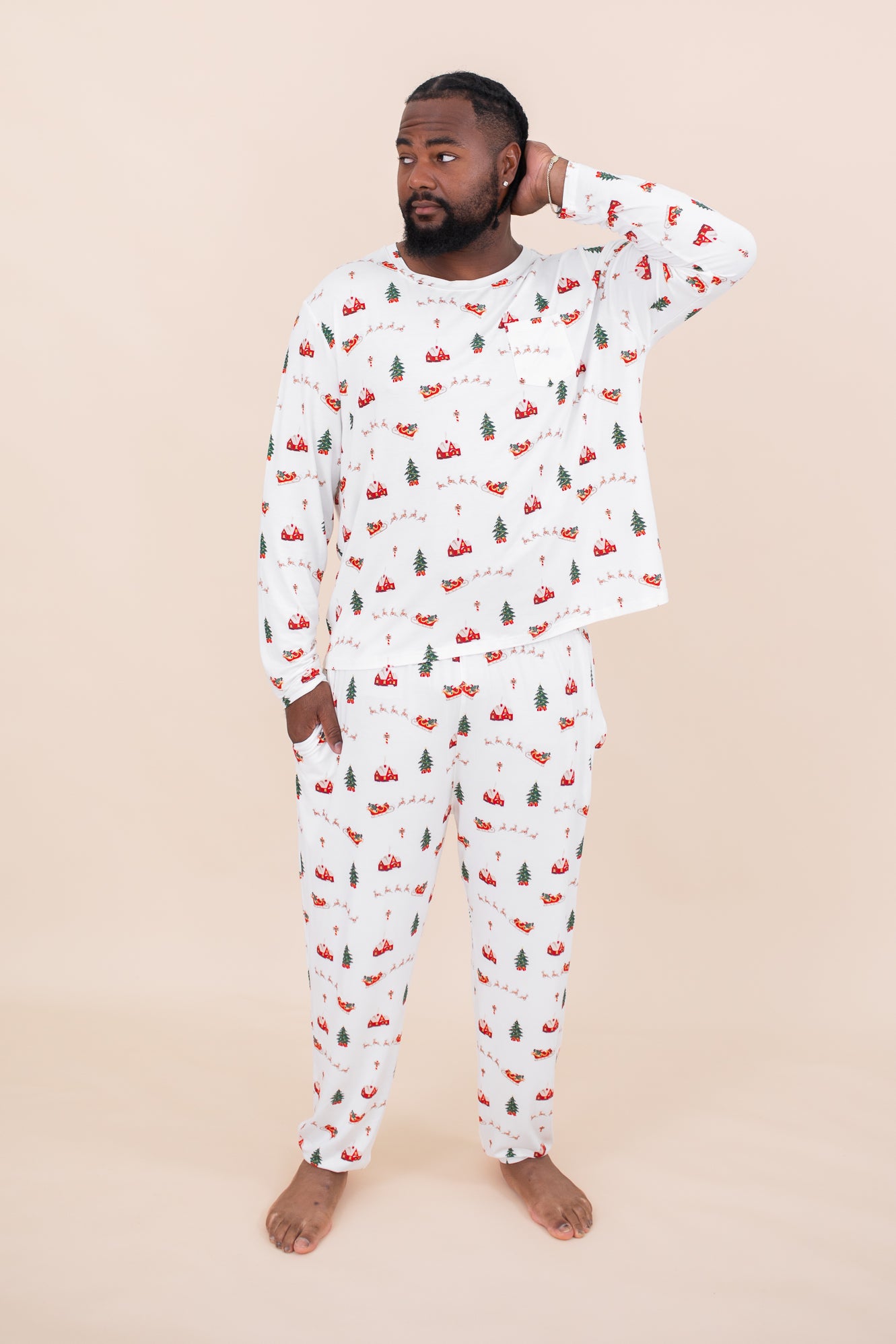 Male model with hand in pocket and one hand on head while wearing the Men's Jogger Set in Santa Sleigh