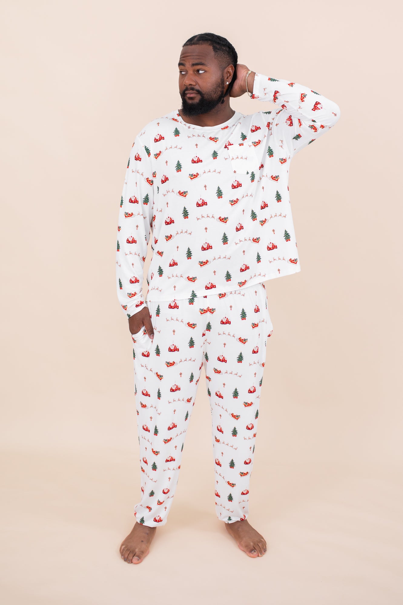 Male model with hand in pocket and one hand on head while wearing the Men's Jogger Set in Santa Sleigh