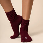 Maroon socks worn by a person on a beige background