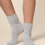 Gray socks worn by a person on a beige background
