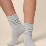 Gray socks worn by a person on a beige background