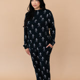 Model looking to the side while wearing the Kyte Women's Jogger Set in Skeleton 