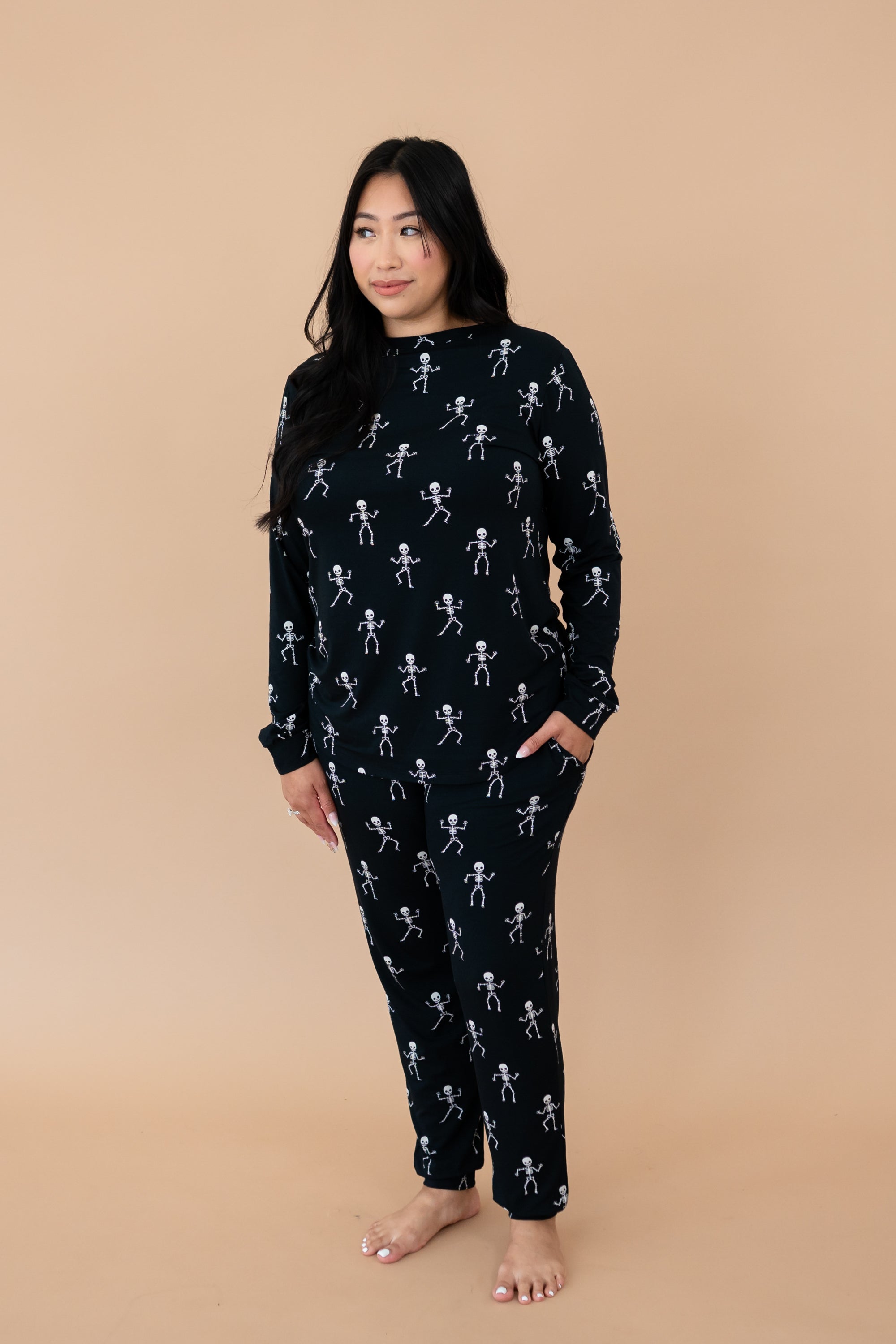 Model looking to the side while wearing the Kyte Women's Jogger Set in Skeleton 