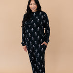 Smiling woman modeling the Kyte Women's Jogger Set in Skeleton 