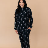 Smiling woman modeling the Kyte Women's Jogger Set in Skeleton 