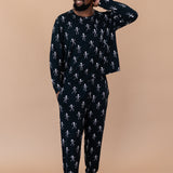 Model with arm on head while wearing the Kyte Men's Jogger Set in Skeleton 
