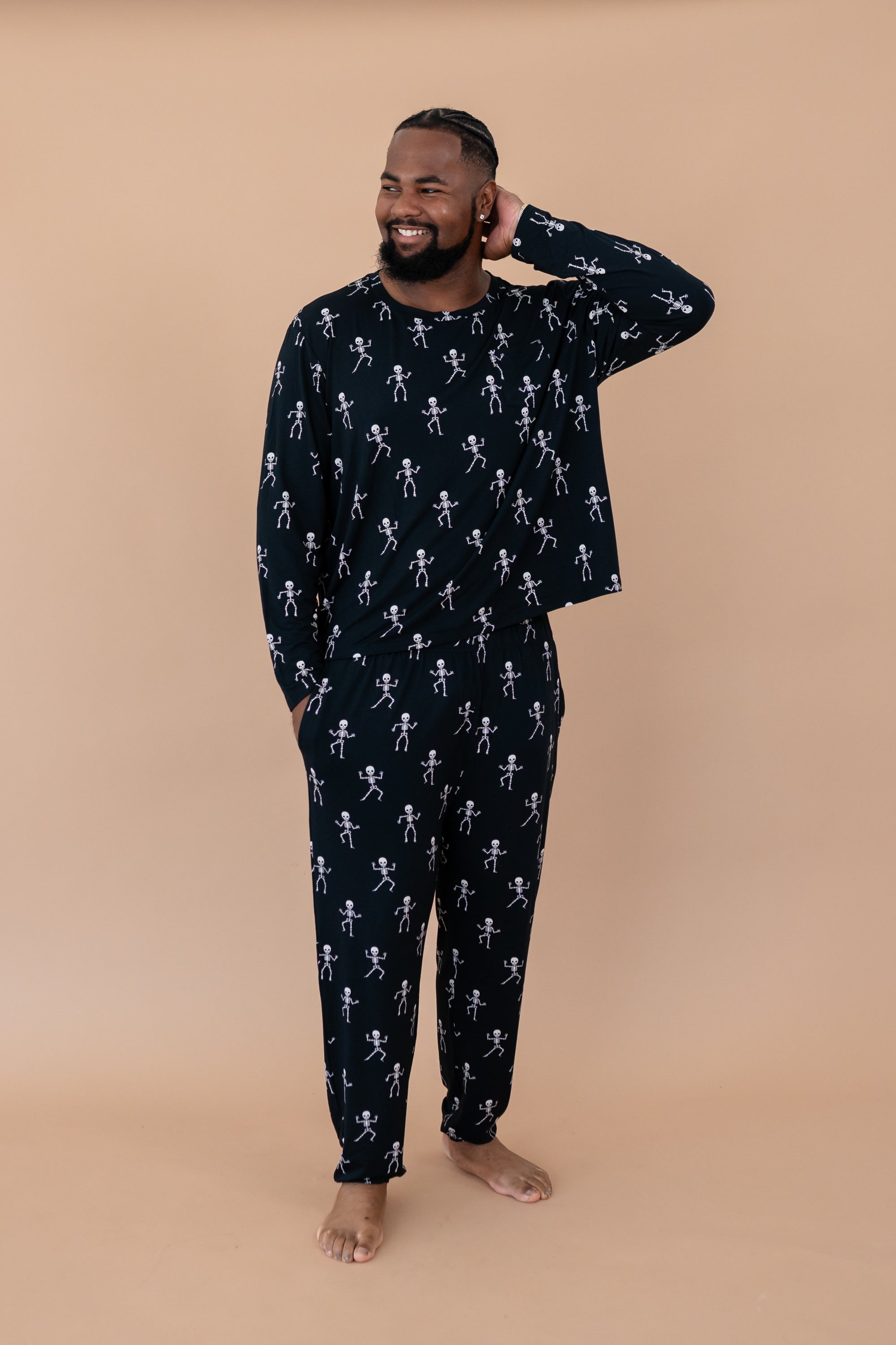 Model with arm on head while wearing the Kyte Men's Jogger Set in Skeleton 