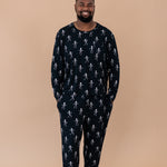 Smiling man with hands in pockets modeling the Men's Jogger Set in Skeleton 
