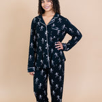 Woman with arm on hip modeling Kyte Long Sleeve Women's Pajama Set in Skeleton 