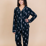 Woman with arm on hip modeling Kyte Long Sleeve Women's Pajama Set in Skeleton 