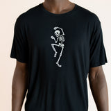 Close up of Modal wearing Black Men's Crew Neck Tee with Skeleton print in center on a beige background